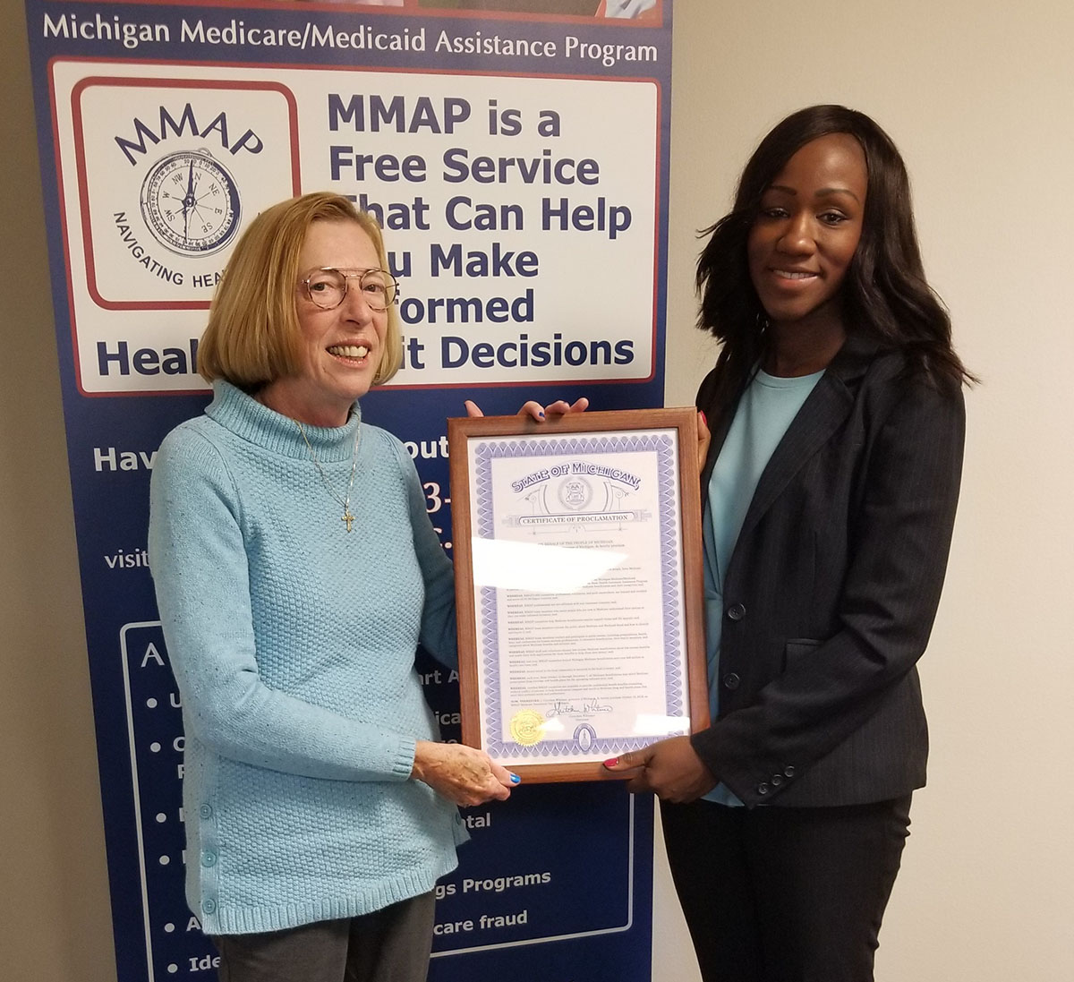 Executive Director of MMAP, Jo Murphy, accepting an certificate of proclamation from Dr. Alexis Travis, Senior Deputy Director of the AASA for MDHHS. 